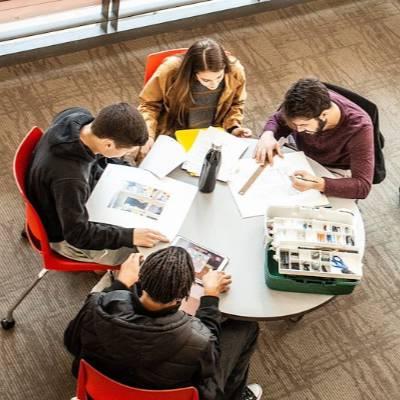 Overhead shot of students sitting at a table studying